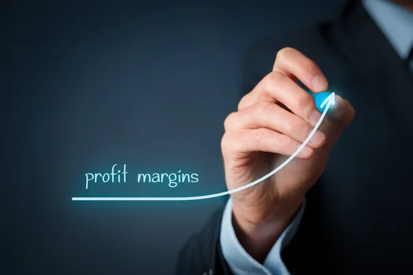 Man with a pen drawing an upward graph labelled 'profit margins'