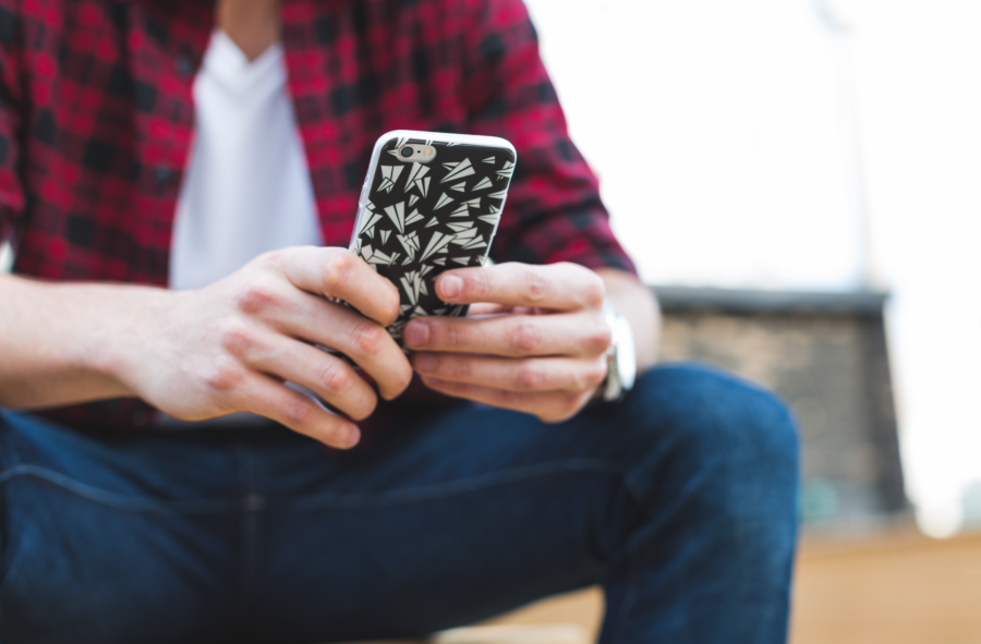 Australian tradie on a phone using job management software to schedule tasks